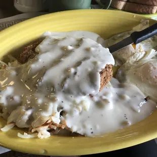 Country fried steak with hash browns and eggs over easy. Gravy all over! Freaking delicious!