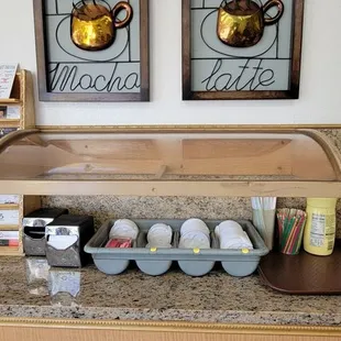 a counter with a display of donuts