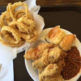 The food; Onion rings, chicken, and baked beans.