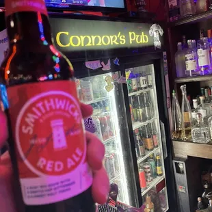 a person holding a beer