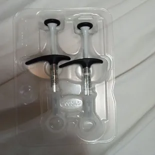 two screws in a plastic container