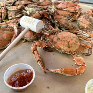 a pile of cooked crabs and a scoop of ketchup