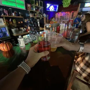 two people toasting at a bar