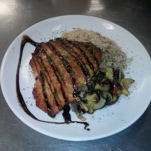 Our pan seared salmon with your choice of 2 sides topped with a citrus balsamic reduction