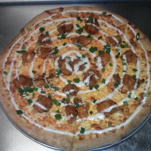Buffalo chicken pizza with blue cheese drizzle and scallions
