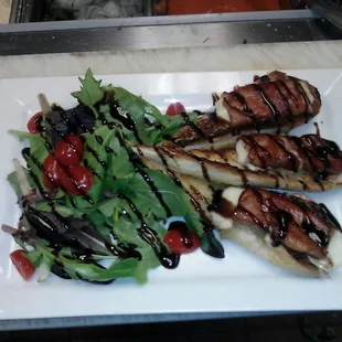 Prosciutto mozzarella over fresh garlic bread and greens topped with balsamic reduction. Good app