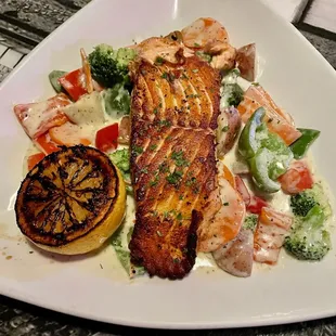 A superb Conroy's Public House Specialty...grilled Atlantic salmon and fresh vegetables in a delicious lemon dill cream sauce!