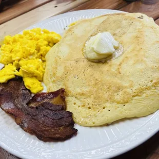 Breakfast for dinner! 3-stack of homemade pancakes topped with butter, scrambled eggs and bacon!