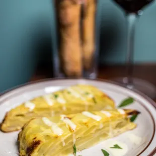 a plate of food and a glass of wine