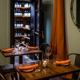 a table set with wine glasses and plates