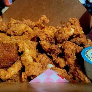 Chicken tenders, ranch, hush puppies, all on a bed of seasoned fries