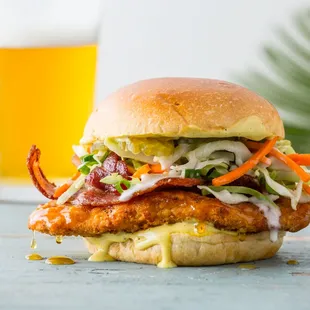 a chicken sandwich with coleslaw and bacon