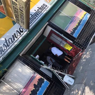 a man sitting in the doorway of a restaurant
