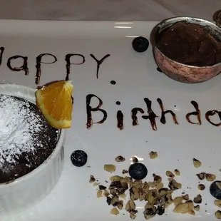 a chocolate dessert with a happy birthday message
