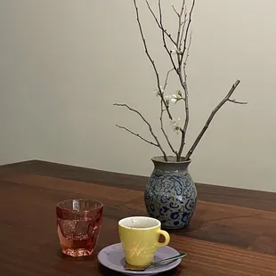 a cup of tea and a vase of flowers