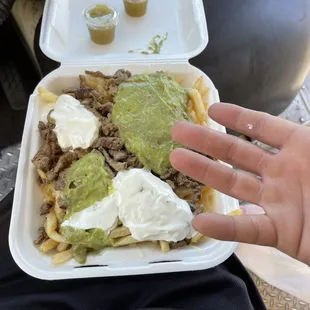 a hand holding a container