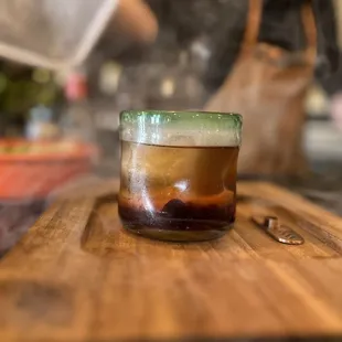 a person preparing a drink on a cutting board