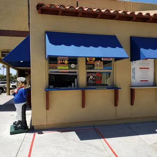 You go to the small window and order your food.