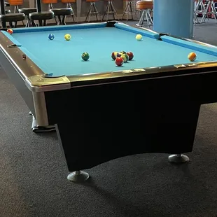 a pool table and chairs
