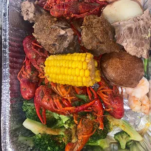 lobster, corn, broccoli, and potatoes