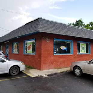 two cars parked in front of a restaurant