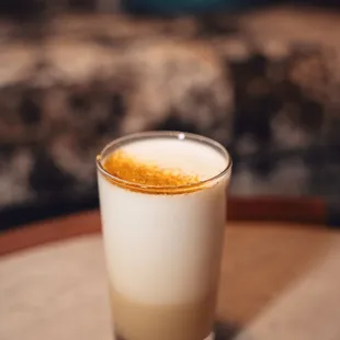 a glass of coffee on a table