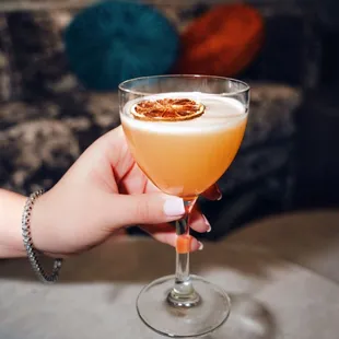 a person holding a cocktail glass