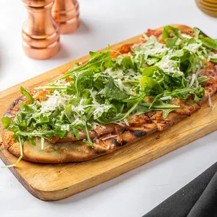 a pizza on a cutting board