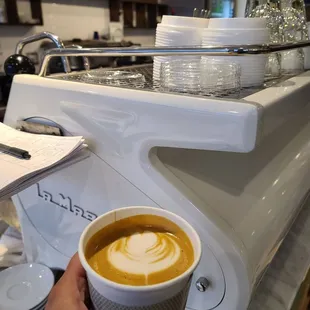 a person holding a cup of coffee