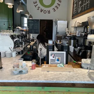 a woman standing behind the counter