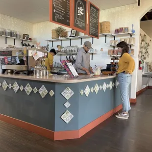 two people standing at the counter