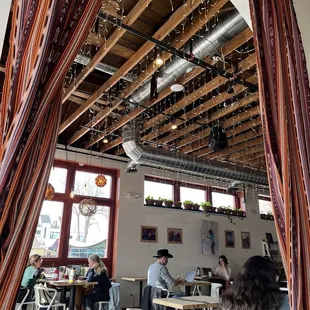 people sitting at tables in a cafe