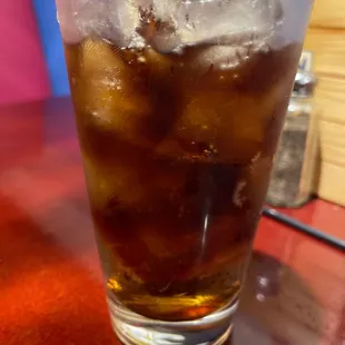 a glass of ice tea on a table