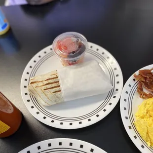 California burrito with a side of fresh fruit.