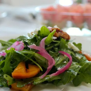 Arugula salad with pickled red onions, grilled peaches and herbed goat cheese