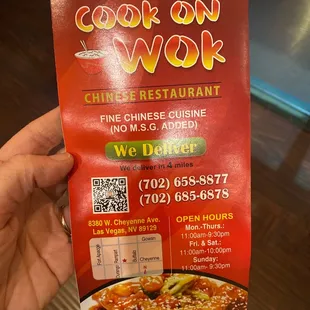 a person holding a menu