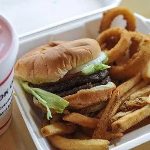 a burger and fries in a styrofoam container