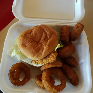 Spicy chicken sandwich, hush puppies and onion rings