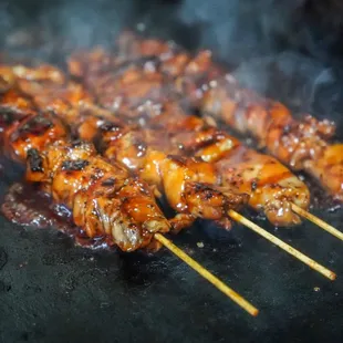 chicken skewers on a grill