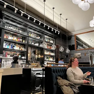 a woman sitting at a table in a restaurant