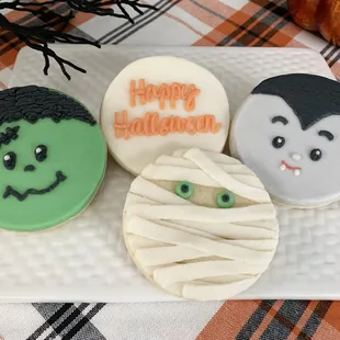 hree decorated cookies on a plate