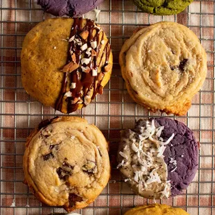 a variety of cookies on a cooling rack