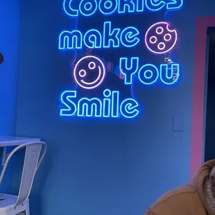 a neon sign that says cookies make you smile