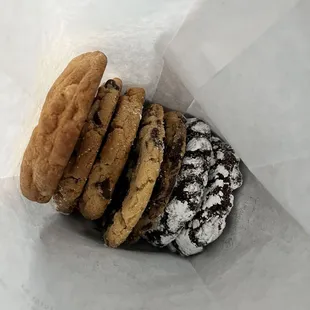 a variety of cookies in a paper bag