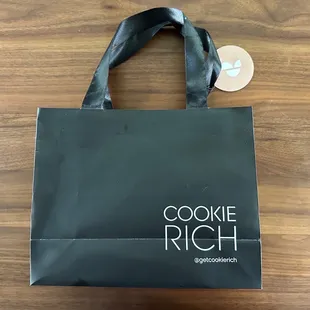 a black shopping bag on a wooden surface