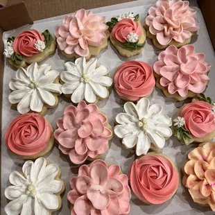 a box of decorated cupcakes