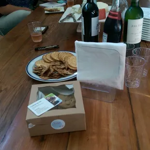 people sitting at a table with bottles of wine