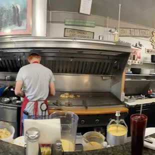 a man cooking in a commercial kitchen