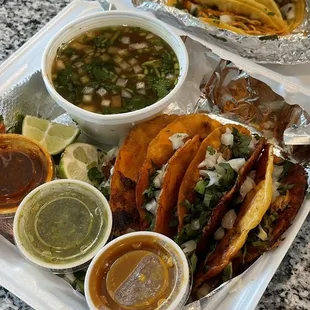 Birria tacos, chicken and carnitas street tacos.
