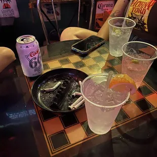 wo people sitting at a table with drinks